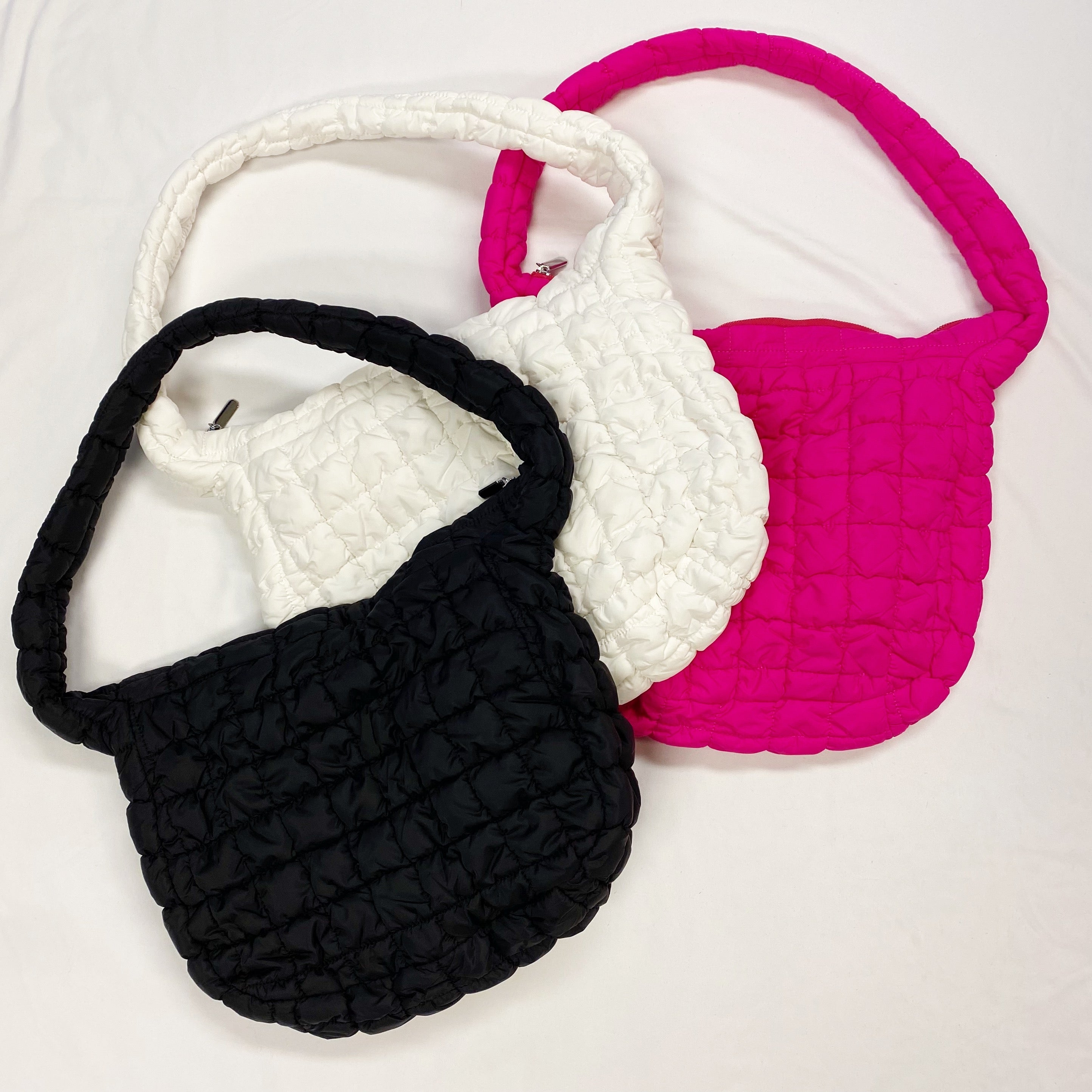 Carry All Quilted Cross Body Bag in black, white, and pink showcasing stylish quilted design.