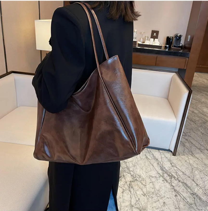 Glossy Retro Tote Bag Stylish Vintage in beige color on a light background, highlighting its spacious design.