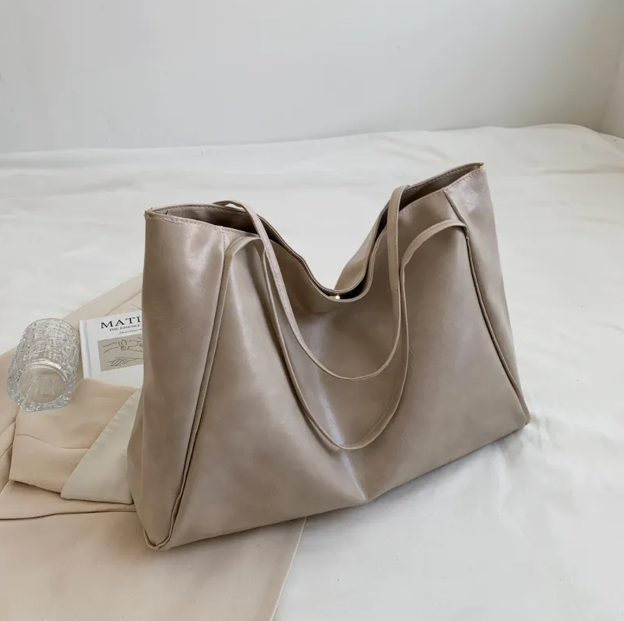 Glossy Retro Tote Bag Stylish Vintage in beige color on a light background, highlighting its spacious design.